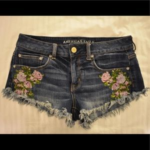 Frayed medium-dark wash American Eagle jean shorts